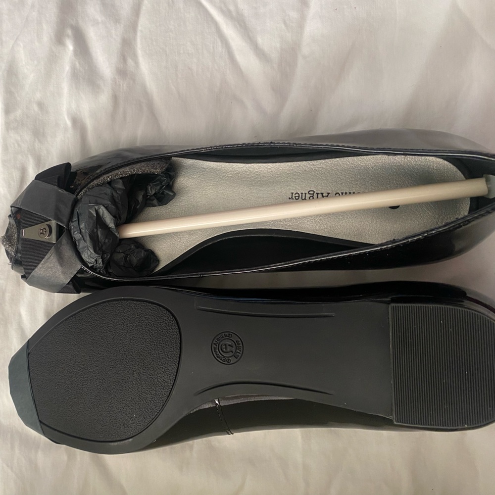 Very classic open toe black patent leather flats.